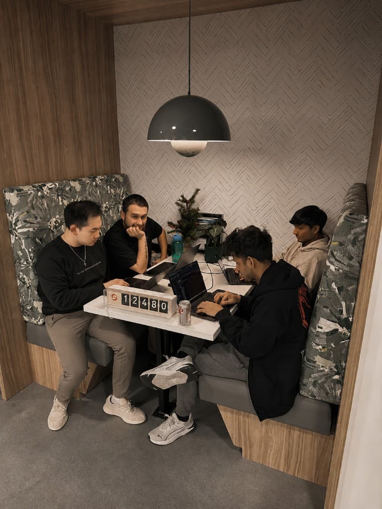 The Sola team huddled around a laptop in their Atlanta office