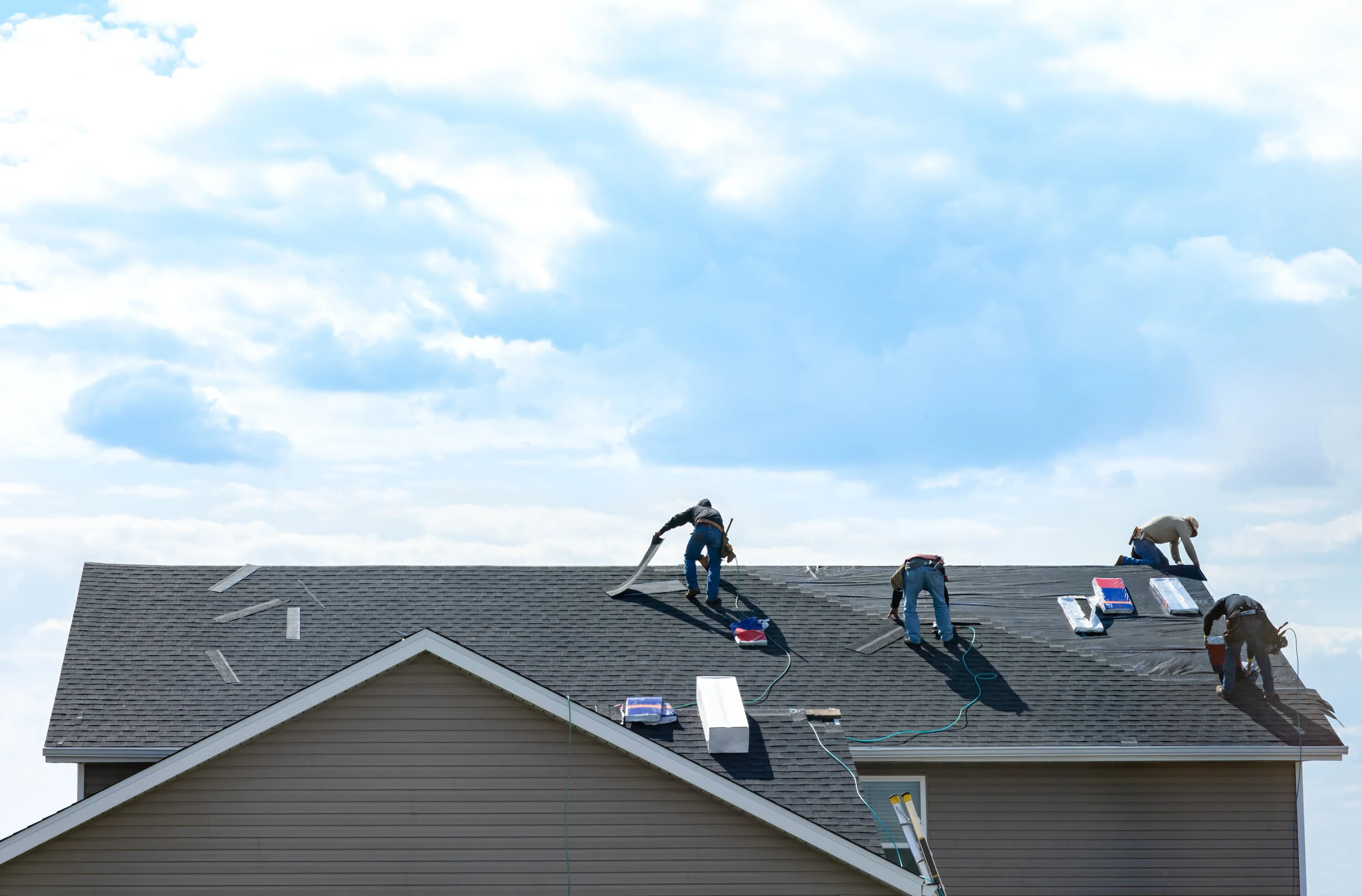 A house in Oklahoma that was damaged by wind and hail getting roof repairs